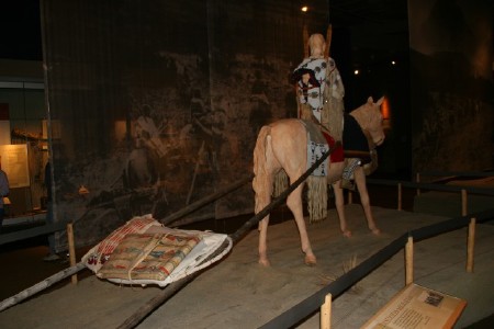Indian on Horseback pulling sled