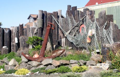 Fishing Floats, Nets and a Large Anchor beside Old Dock Piers