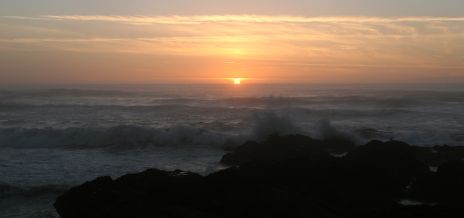 Waves Crashing Against Rocks at Sunset